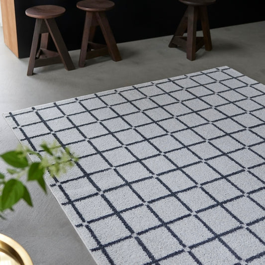 チェック柄のラグがリビングに敷かれている様子