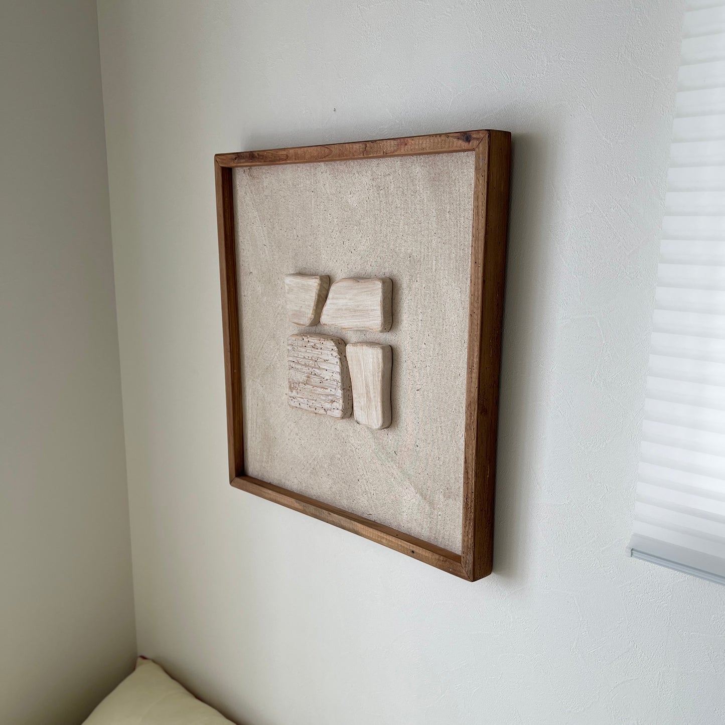 ベージュの立体的なウッドピースが貼り付けられたアート