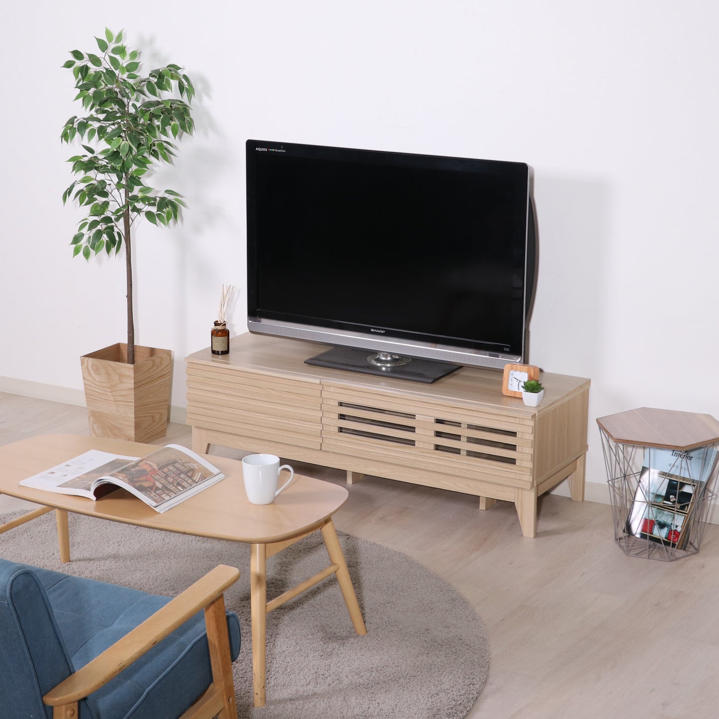 格子デザインのナチュラルウッドのテレビボードを部屋に置いている様子