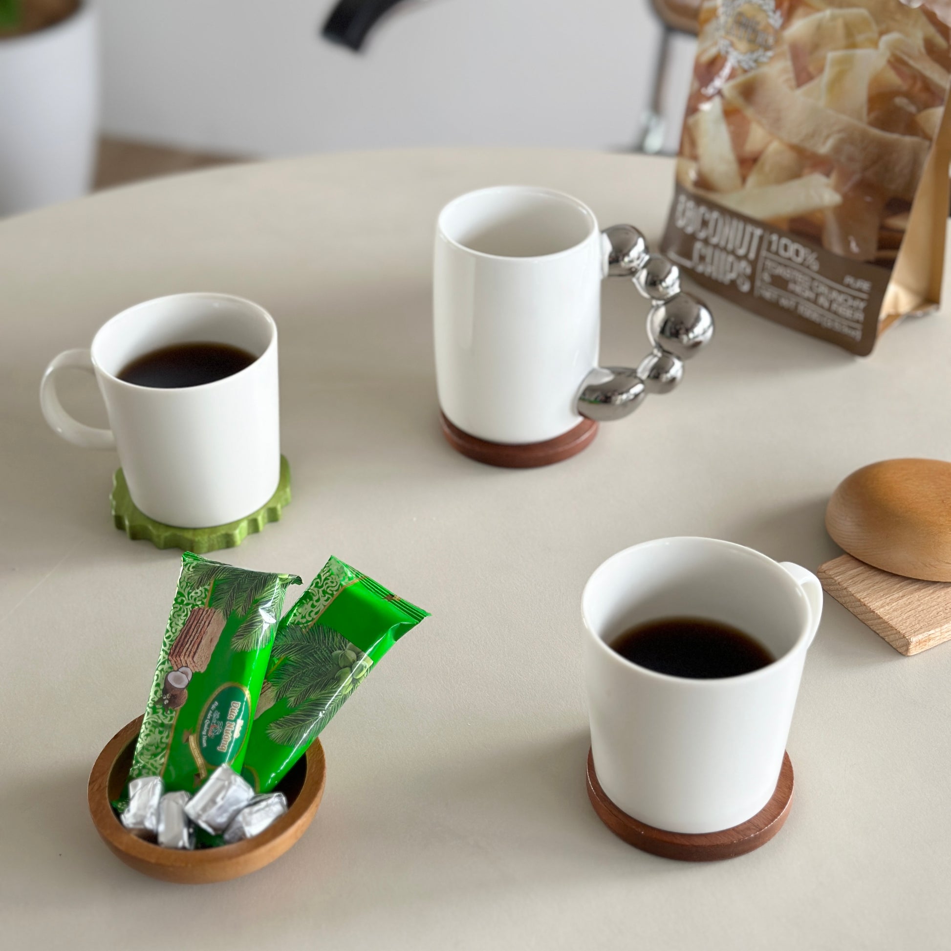 コーヒーが入った白のコップが二つとお菓子が置かれてある様子