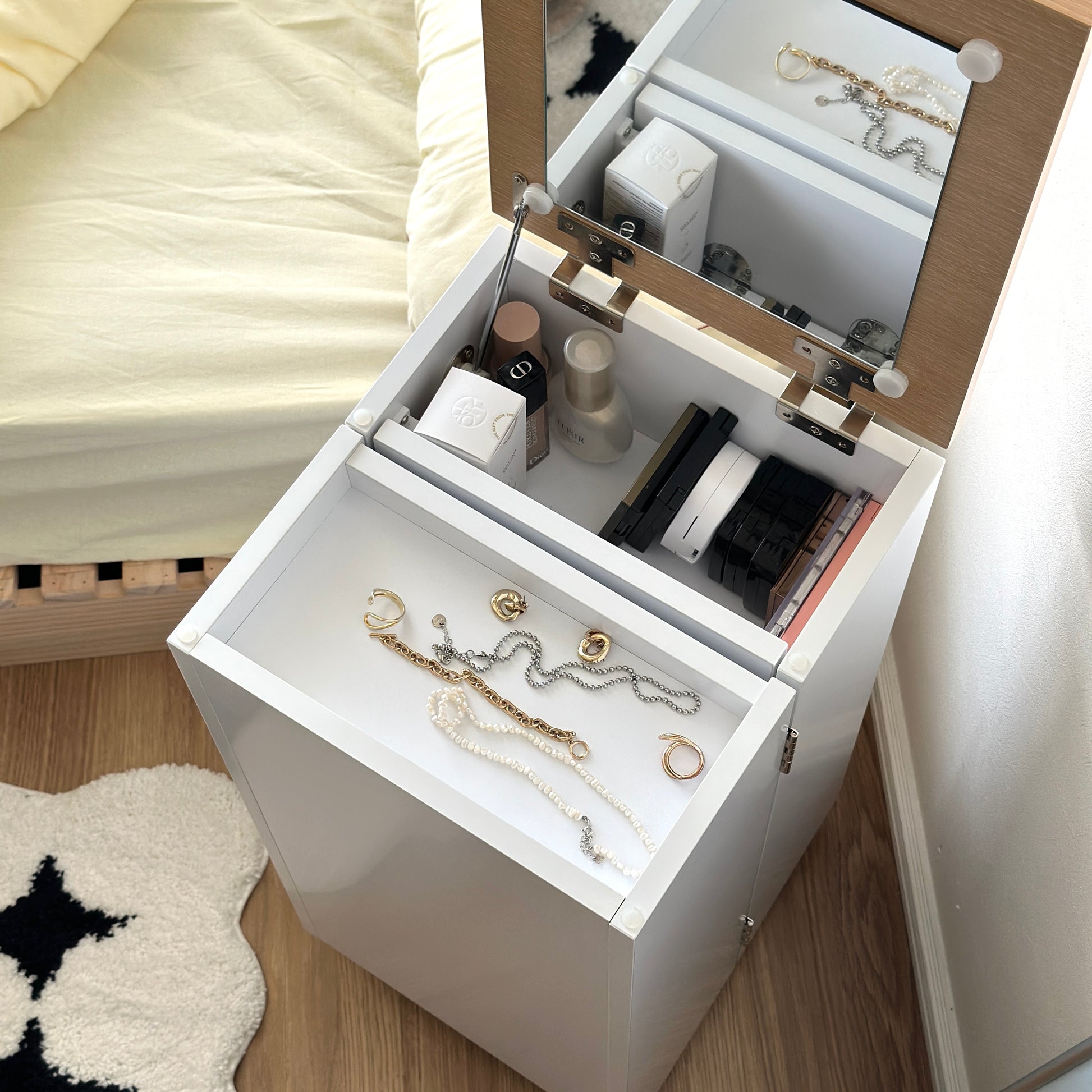 ホワイトのキャスター付きコスメワゴンにアクセサリーやメイク道具を収納している様子