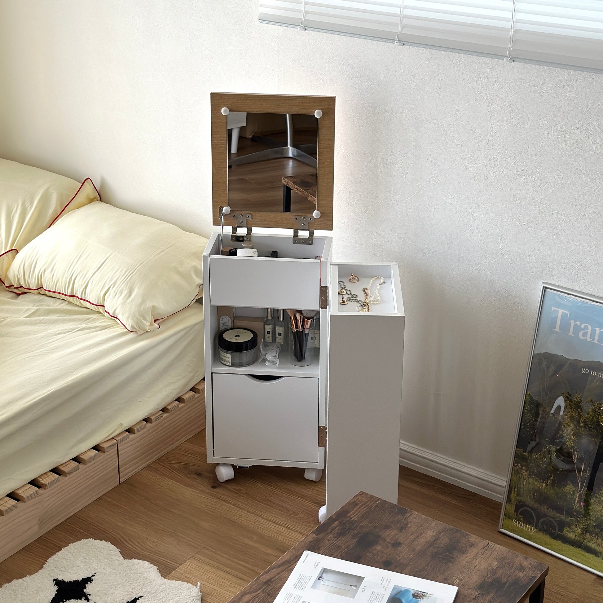 ホワイトのキャスター付きコスメワゴンをベッドサイドに置いている様子