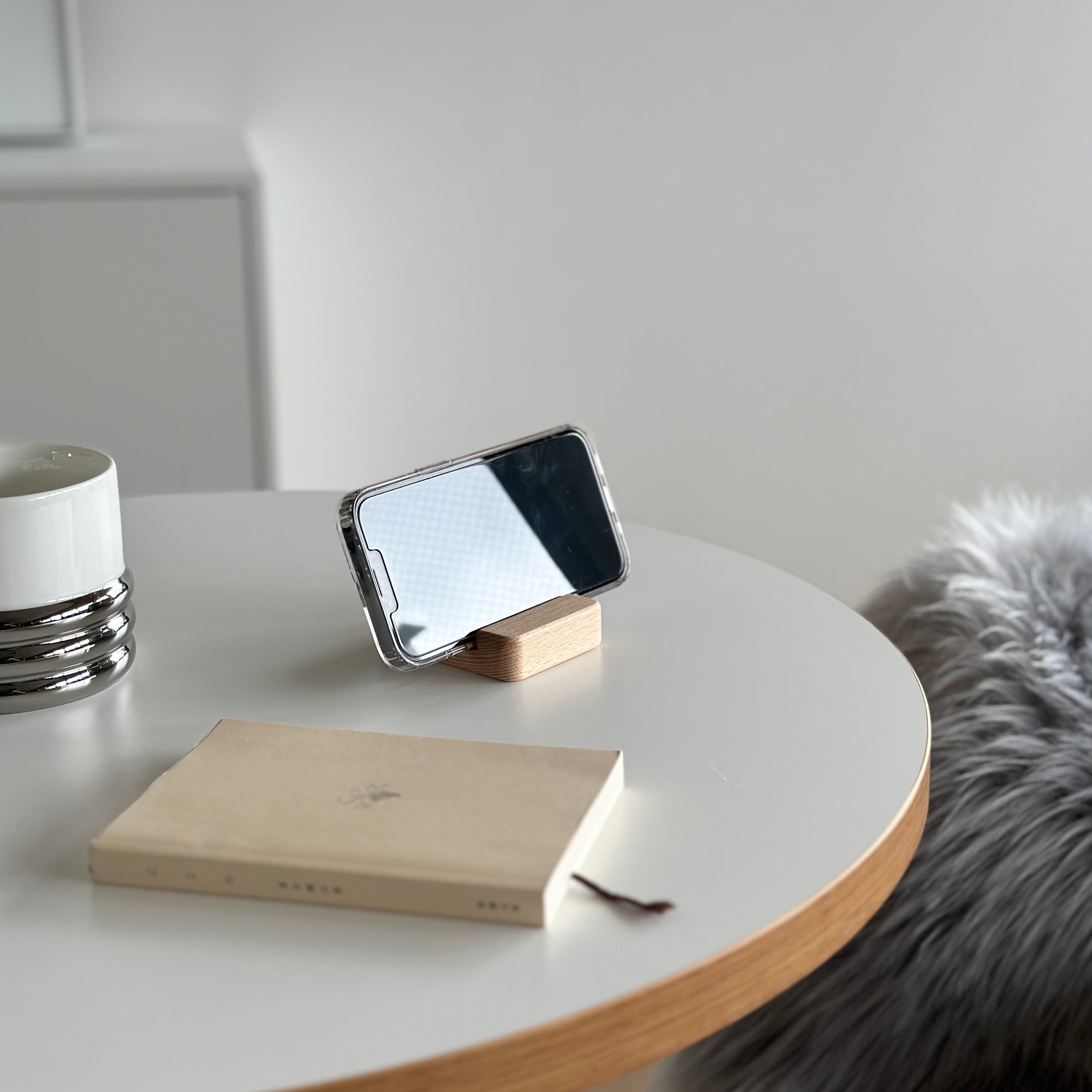 木製のスマホスタンドにスマホを立てている様子