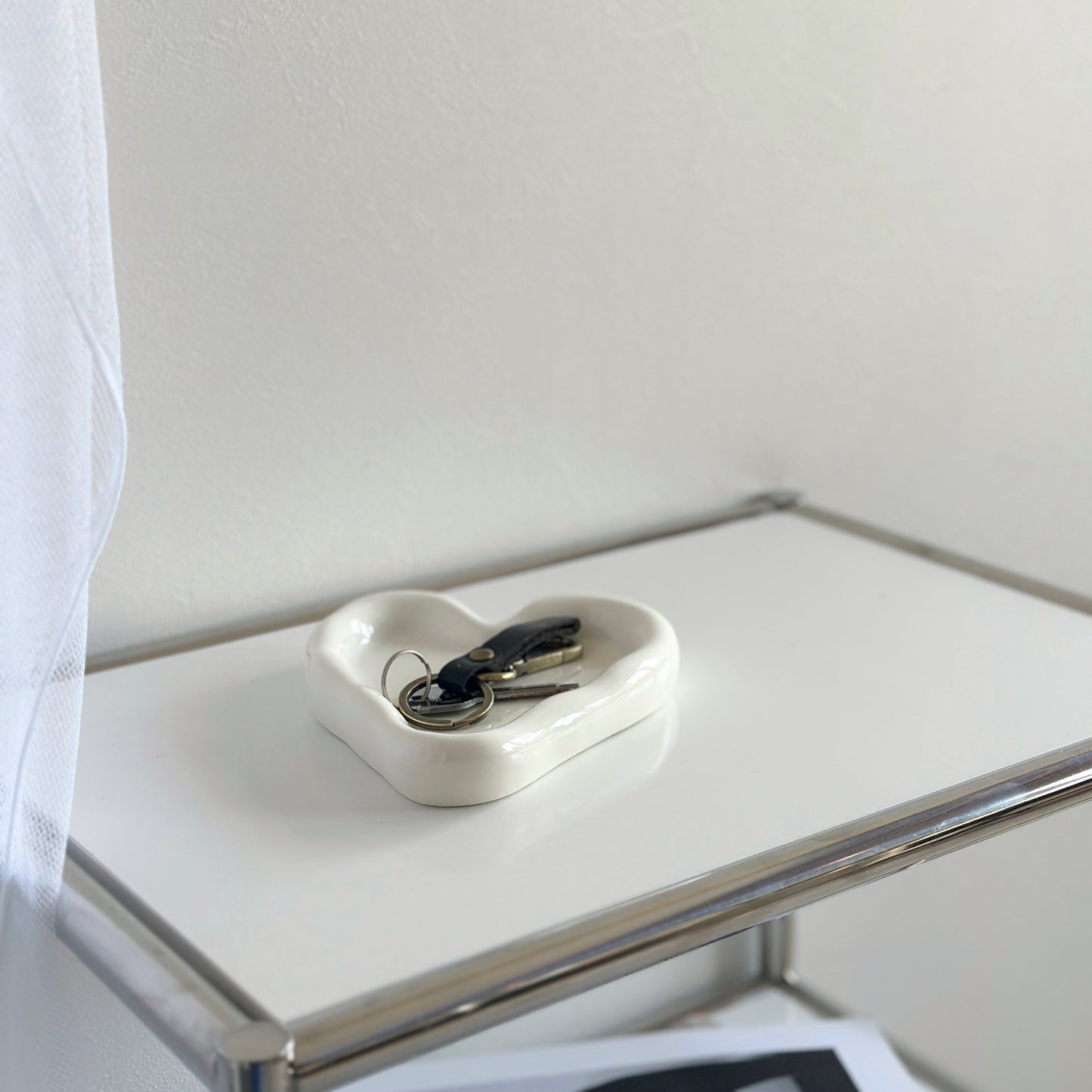 縁があるホワイトのハート型のプレートに鍵が乗っている様子