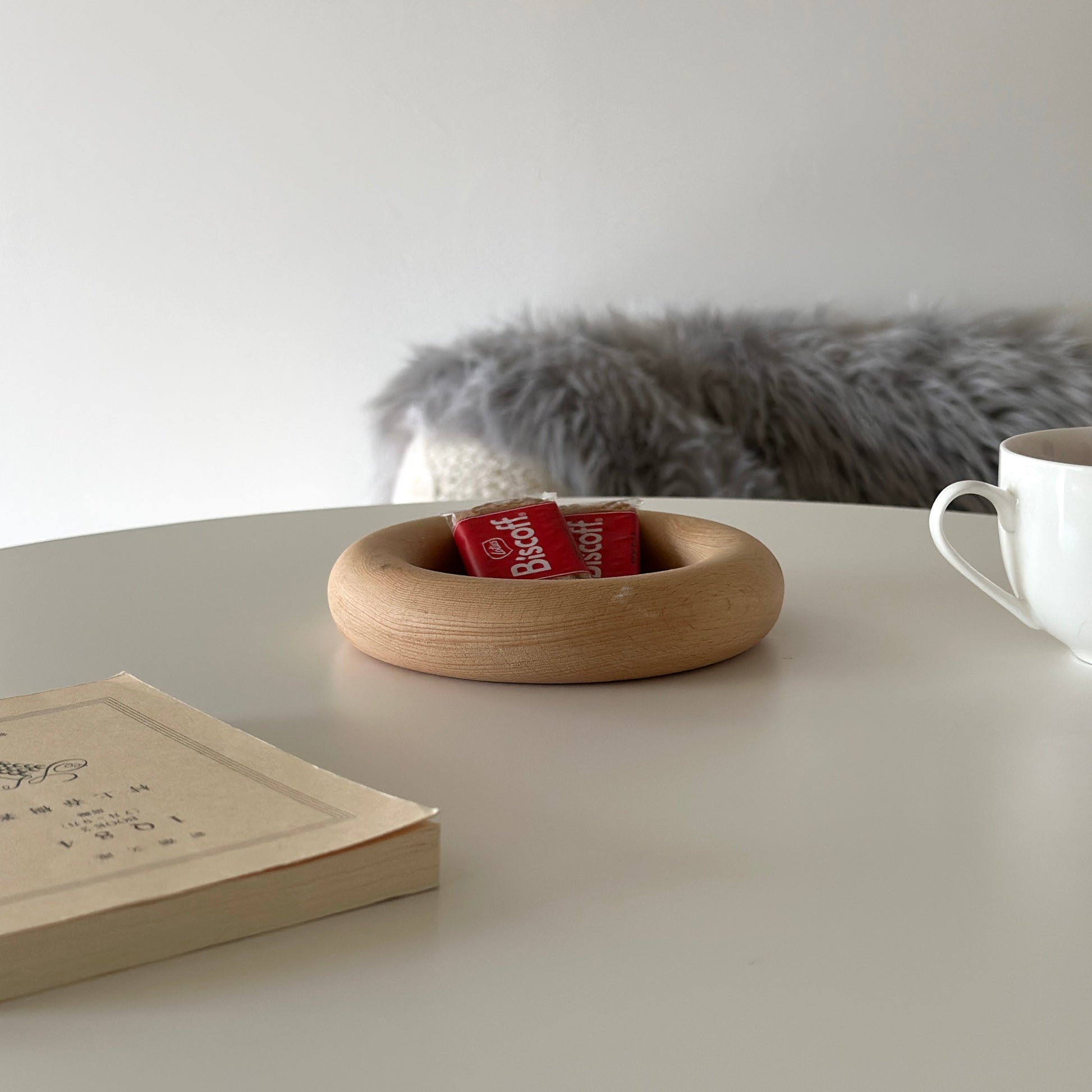 お菓子がのったフチがぽってりとした木のプレートが置かれてある。