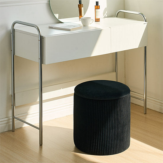 ブラックの楕円型のプリーツのスツールがドレッサー前に置かれている様子