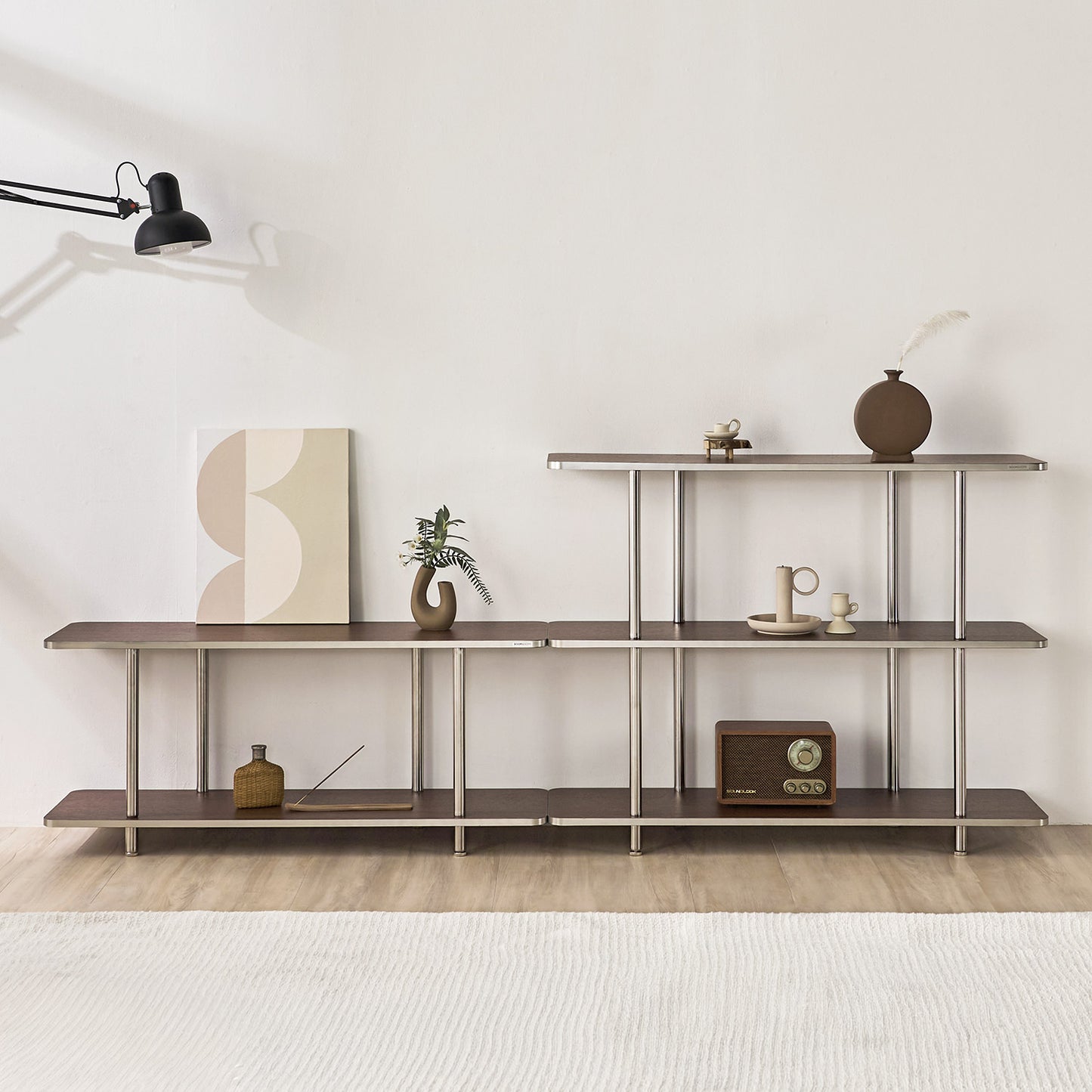 2段と3段のブラウンのオープンシェルフに花瓶やポスター、スピーカーなどが置かれてある様子