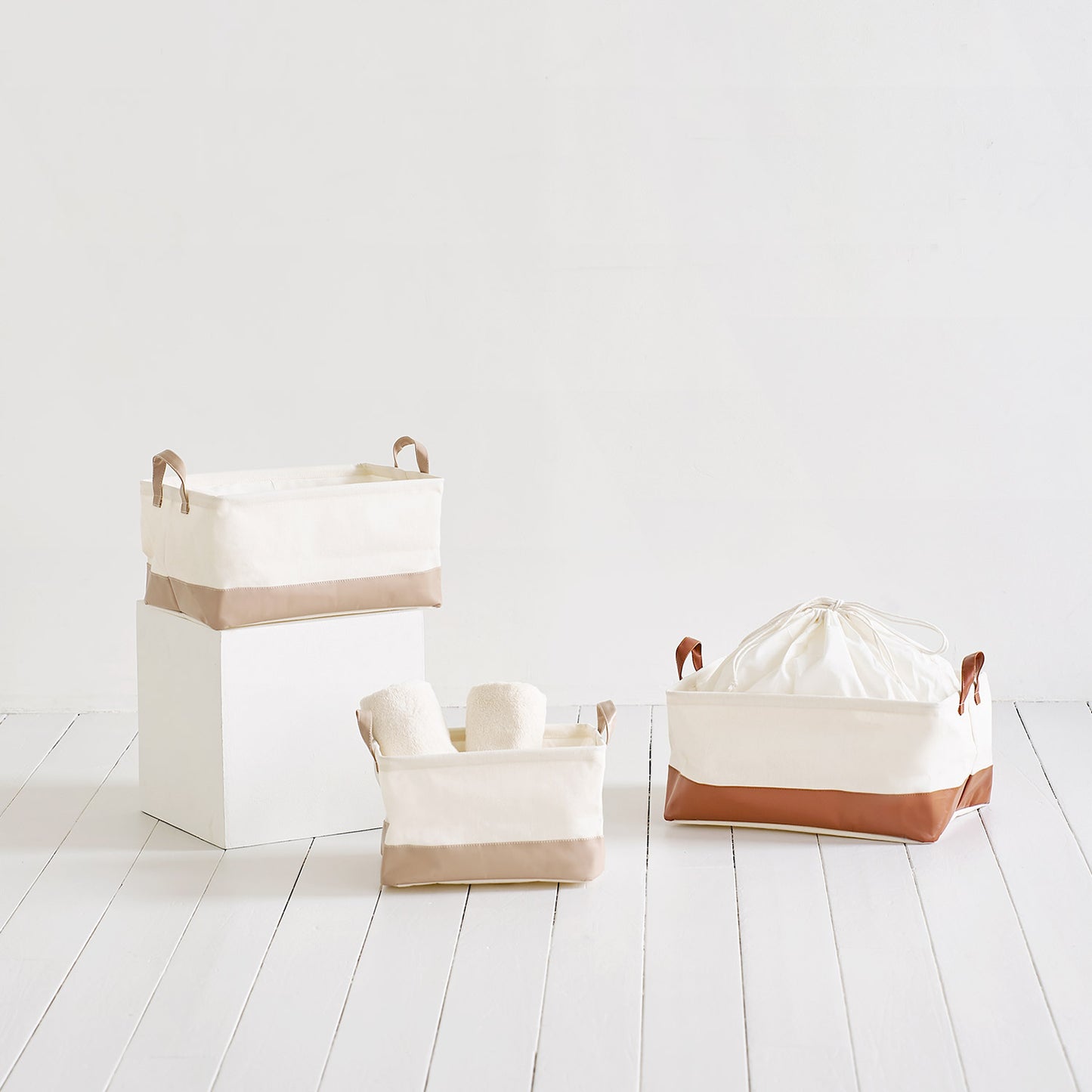 ブラウンのレザーと白地の巾着バスケットとベージュのレザーと白地の巾着バスケット