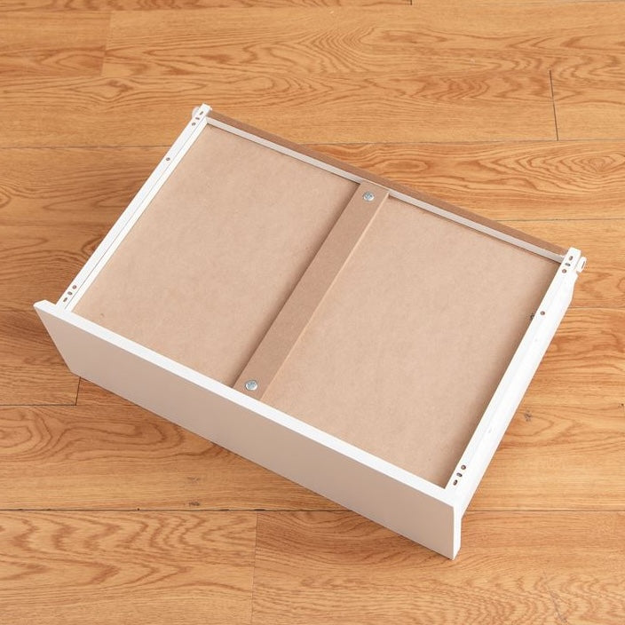 白の引き出しが4段のチェストの引き出しを1段引き抜いて裏面を見せている写真