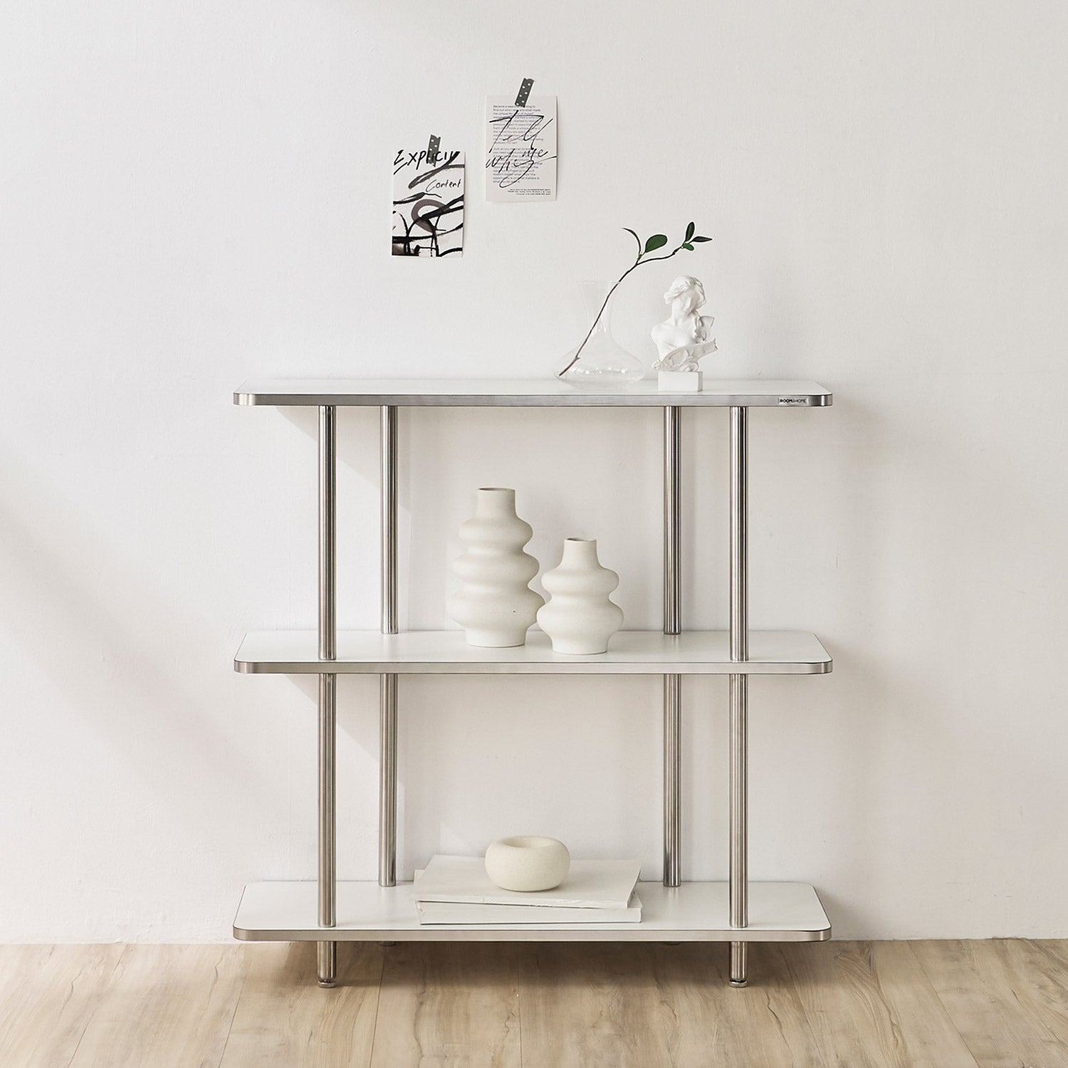 3段ホワイトのオープンシェルフに花瓶や置物を置いている様子