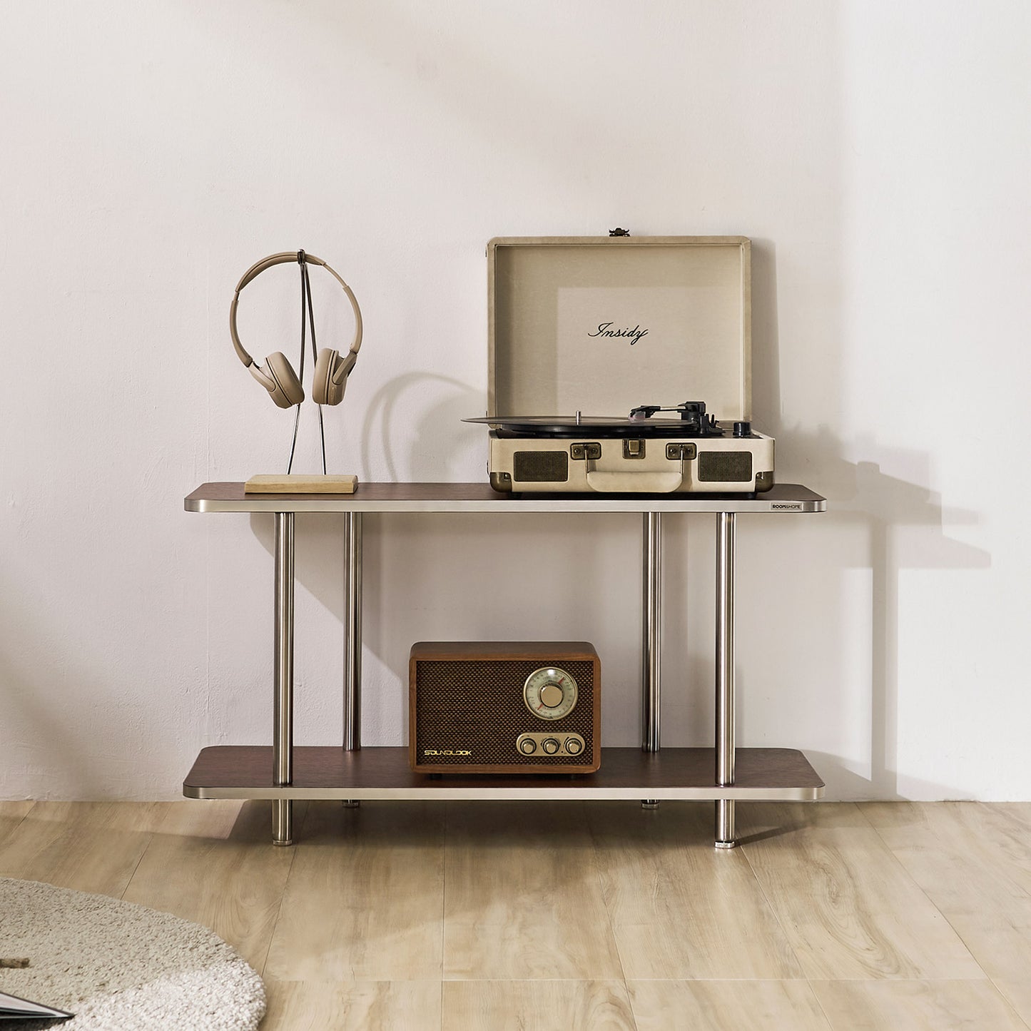 2段のブラウンのオープンシェルフにヘッドホンやレコードプレイヤー、スピーカーが置かれている様子