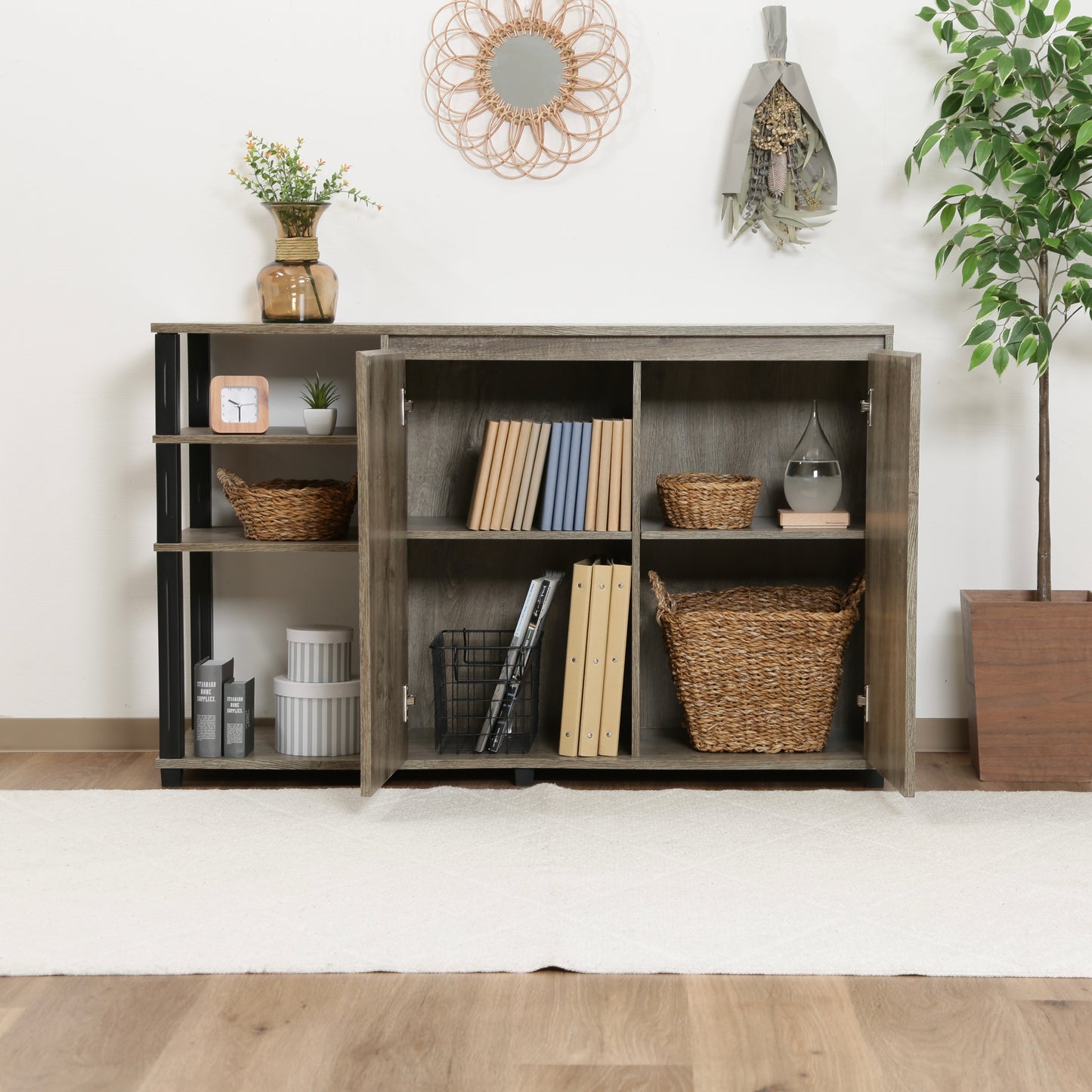 オープンラックが一体になった、ウッド素材のキャビネットの中に本や小物が収納されている様子