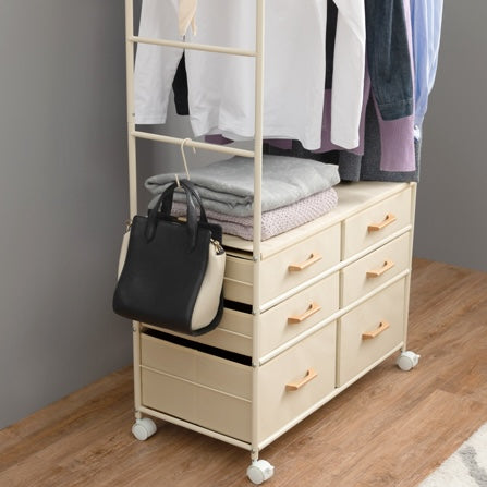 ファブリック素材の収納付きハンガーラックにベッグや毛布が置かれている