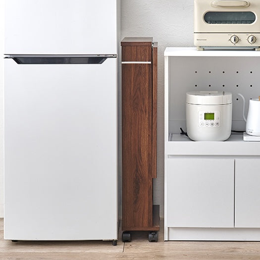 折り畳まれたバタフライテーブルブラウンが冷蔵庫とキッチンシェルフの間に置かれている様子
