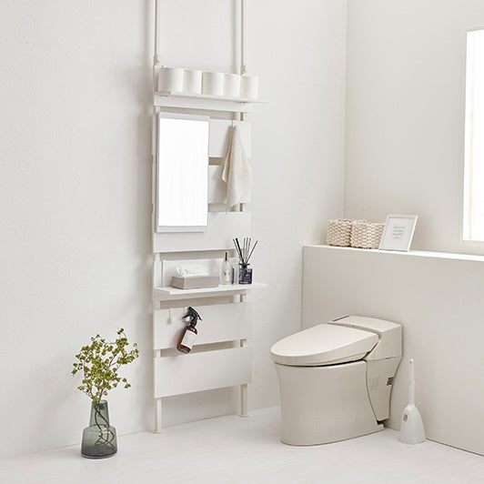 ホワイトの突っ張りミラー付きラックをトイレに設置している様子