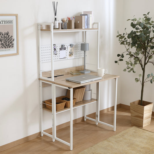 天板が折りたためる収納棚が付いたデスクにパソコンや本が置かれている様子