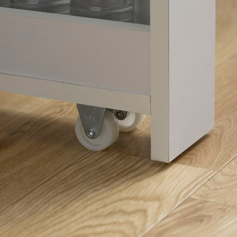 隙間に収まる白の収納ワゴンのキャスターのアップの写真