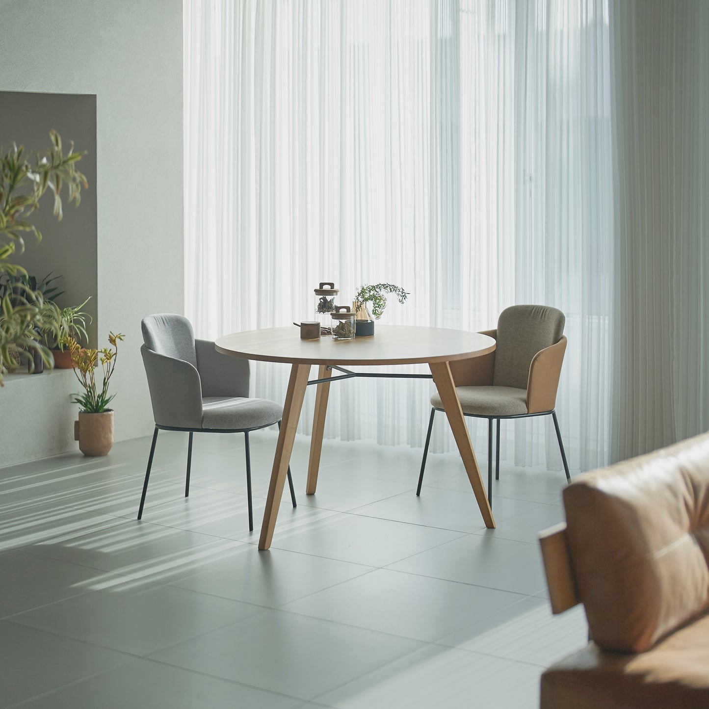 部屋のリビングで天然木の素材を使用した直径110cmの円形ダイニングテーブルにグレーの張り地のチェアを合わせたインテリアコーディネート