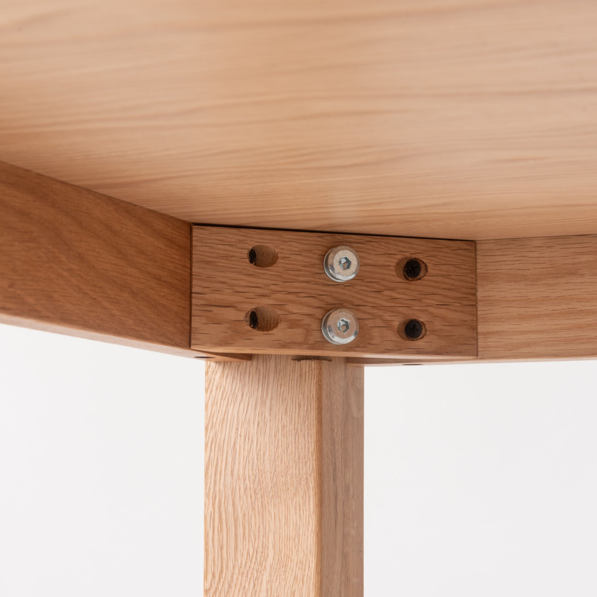 天然木オーク材を使用したシンプルなダイニングテーブルの天板裏の留め具のアップ