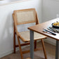 ナチュラルのラタン素材の椅子がテーブルの前に置かれている様子