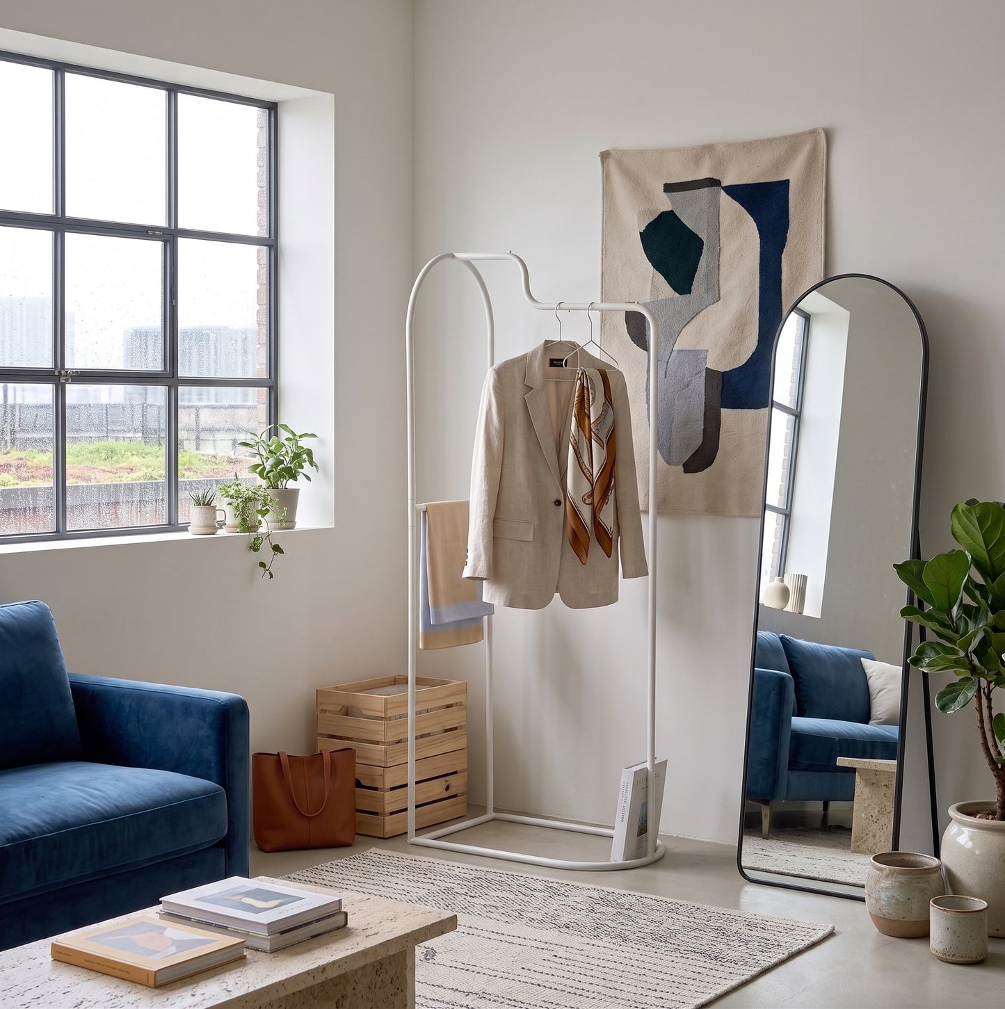 Roomnhomeの白い金属製アーチカーブハンガーにベージュのブレザージャケットが掛かっている写真