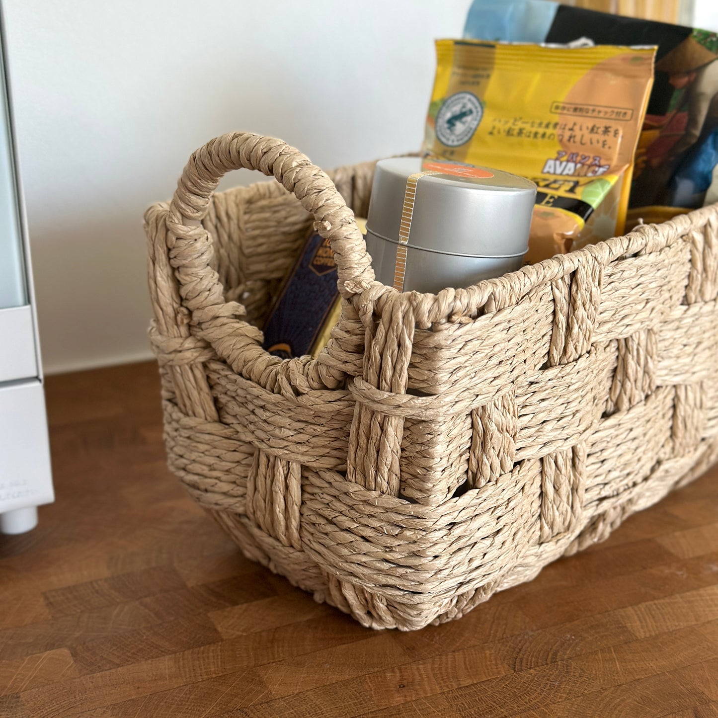 キッチンで取手がついたロープ編みのバスケットにコーヒーセットが収納されている様子