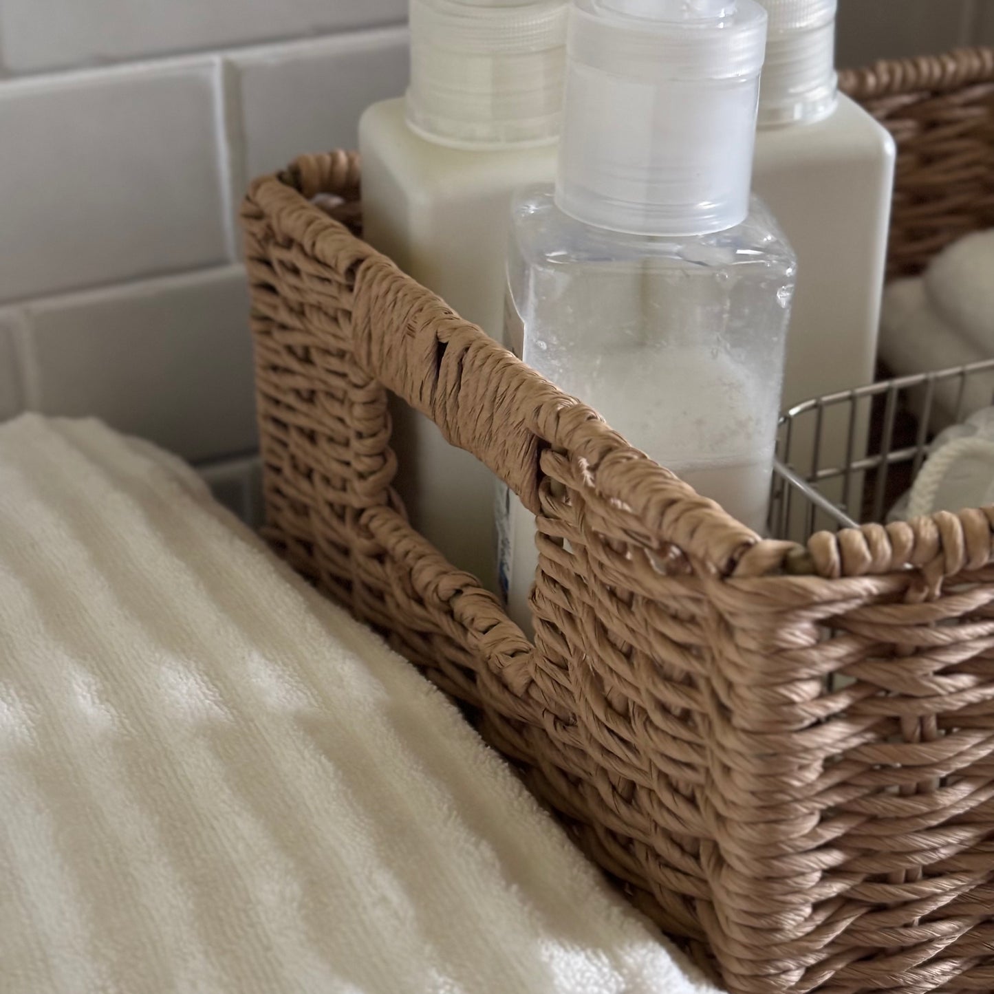 手編みの折り畳み式ペーパーコードバスケットの中に柔軟剤などを入れている様子