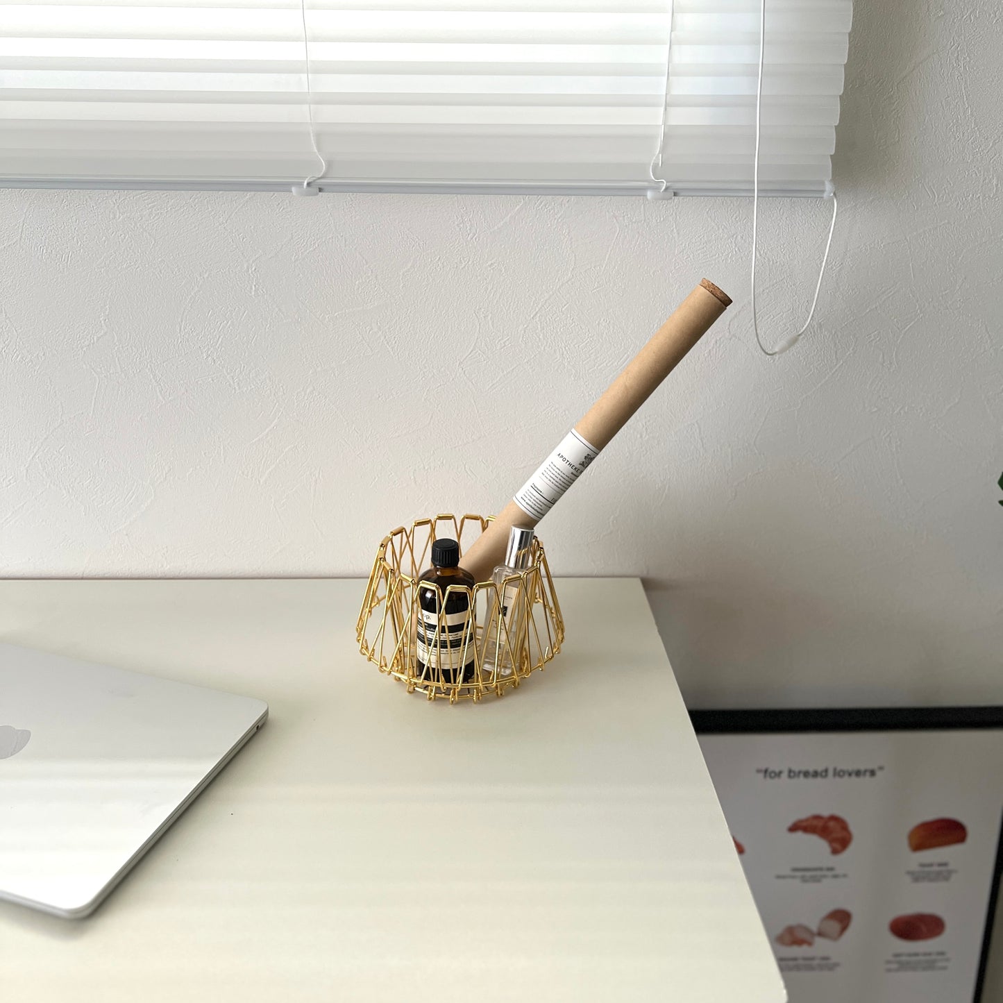 ゴールドのワイヤーバスケットの中に香水とお香が入っている様子