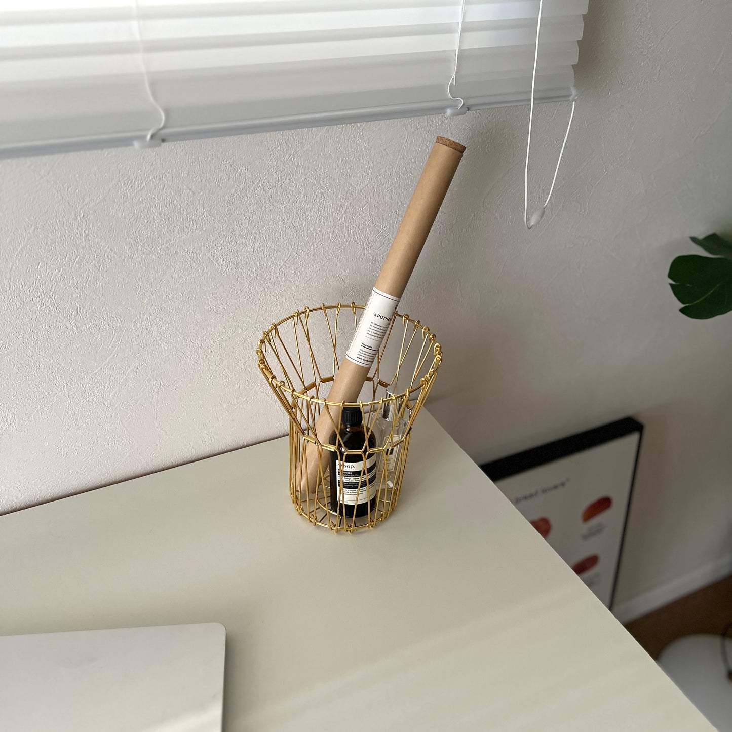 ゴールドのワイヤーバスケットの中にお香と香水が入っている様子