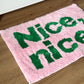 Nice,nice.のレタリングがされてあるピンクのミニラグ