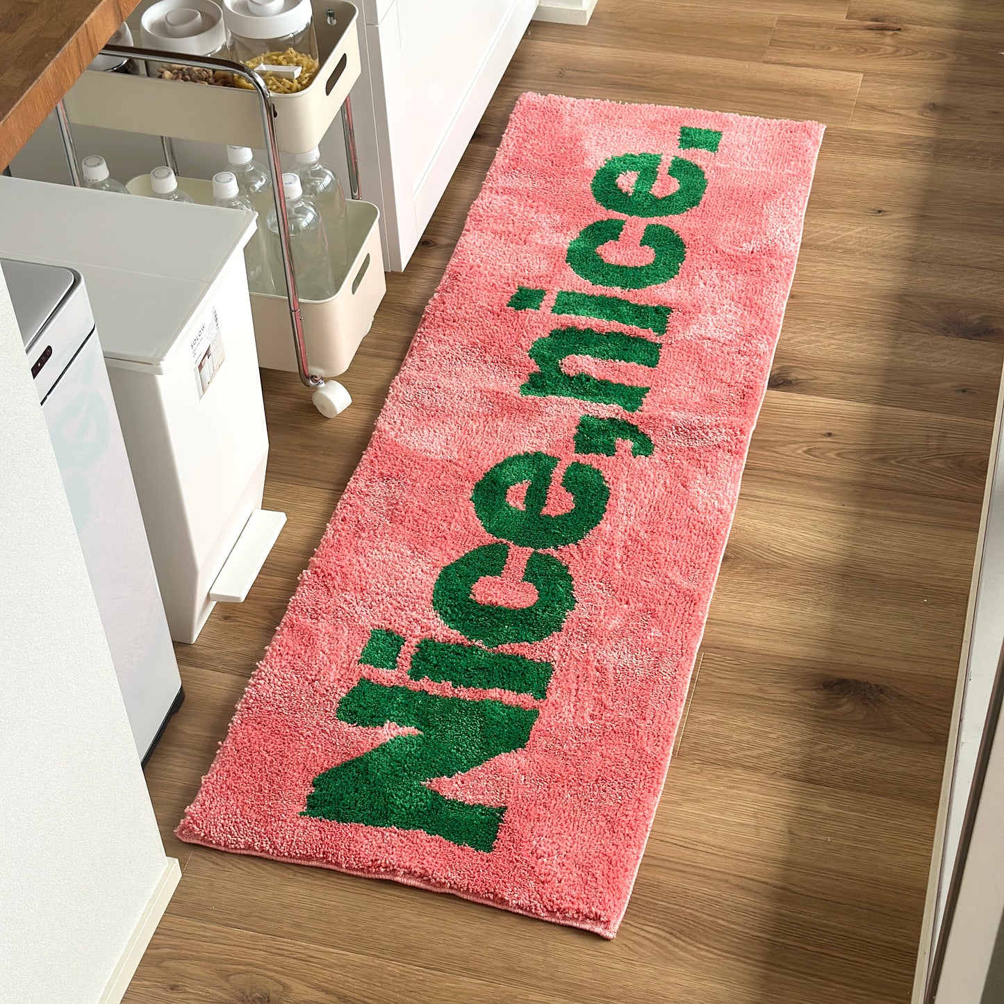 Nice,nice.のレタリングがされているピンクのロングラグ