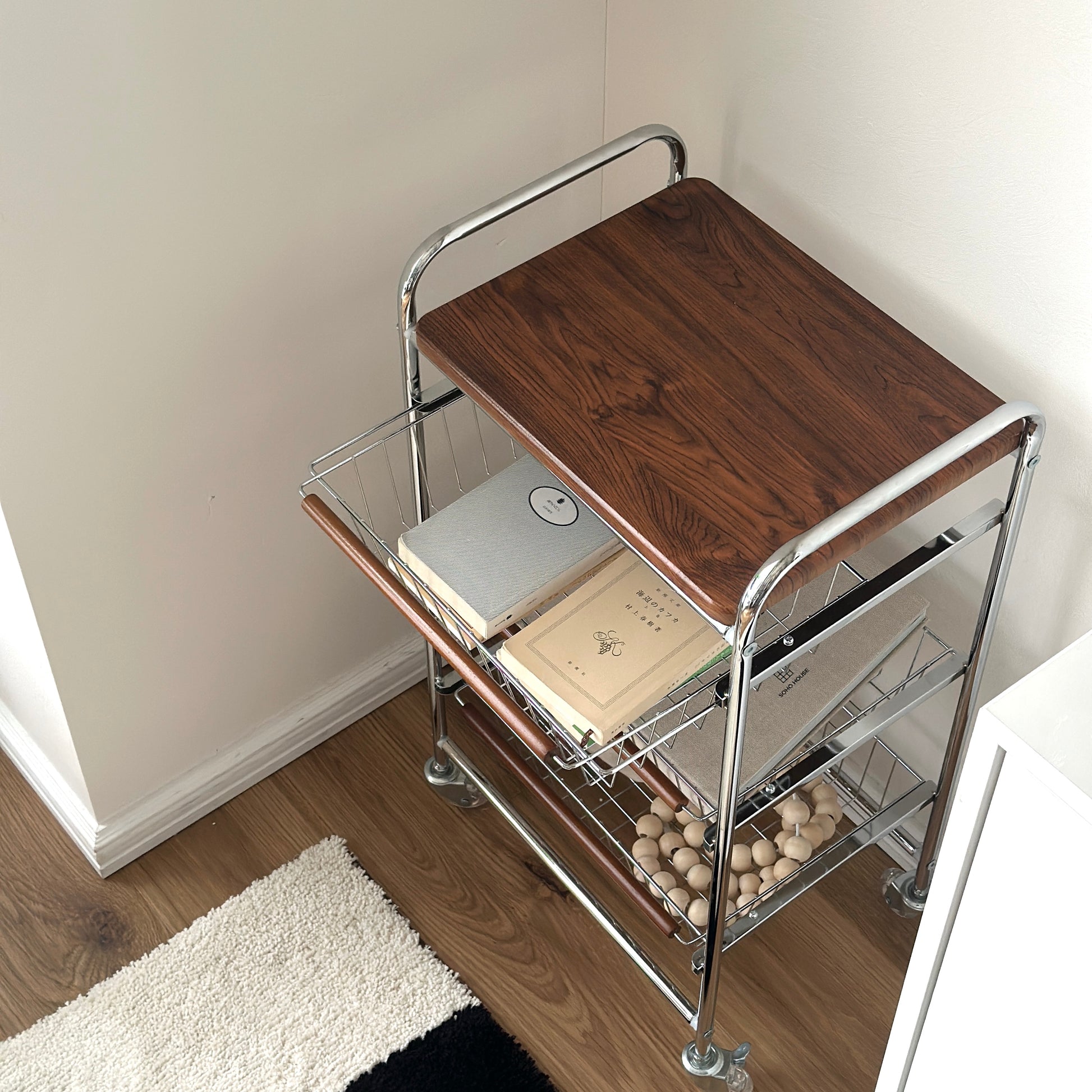 ステンレスとウッド天板の収納ワゴンに文庫本などを収納している様子