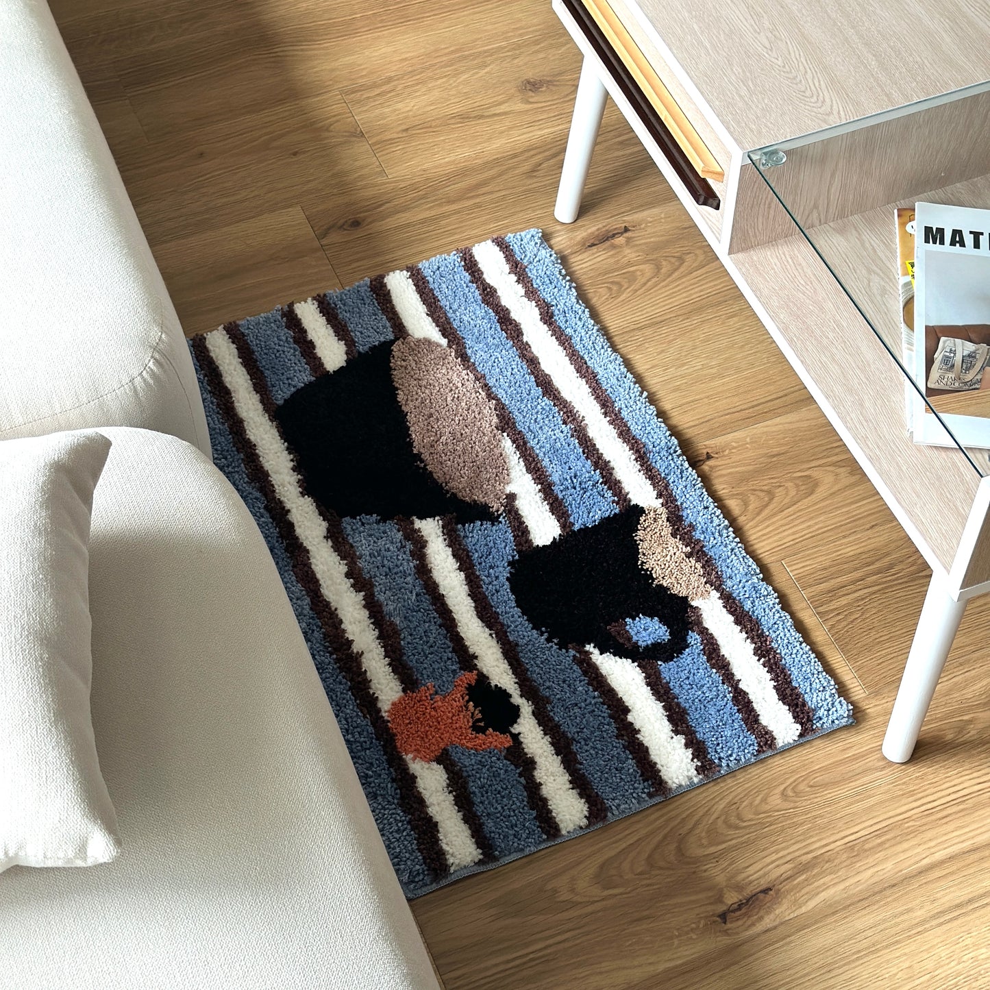 コーヒーカップがモチーフのミニラグをソファとローテーブルの間に敷いている様子