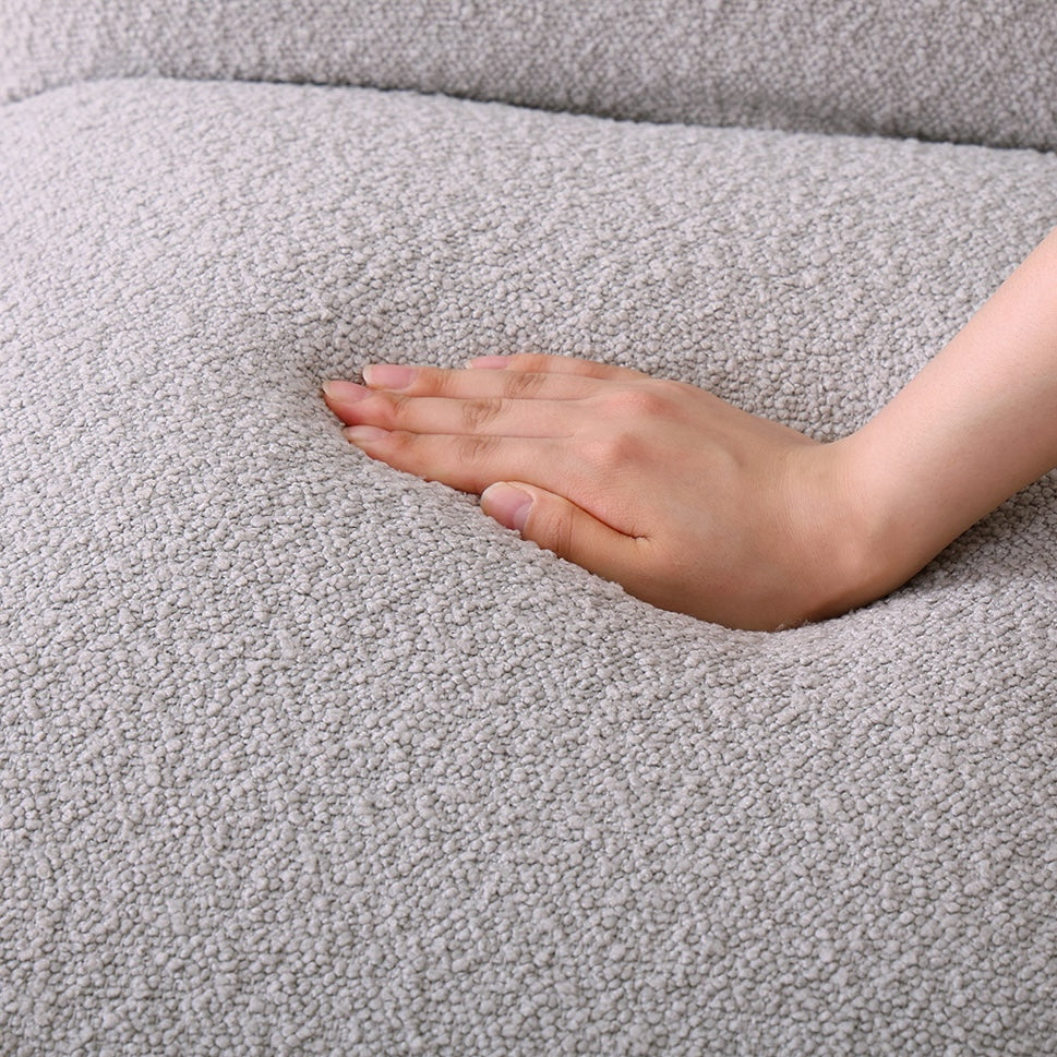 グレーのブークレ座椅子を手で触っている様子